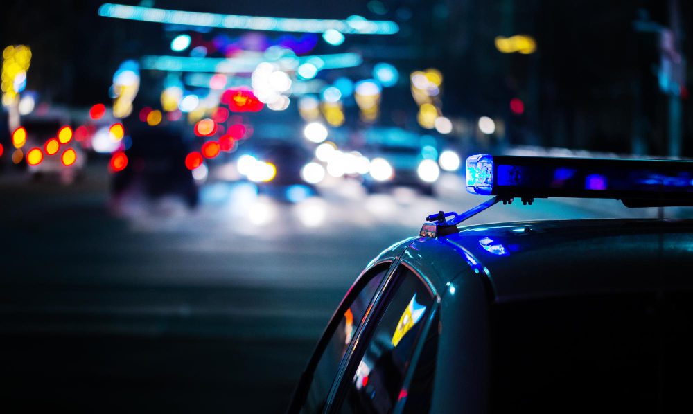 night-police-car-lights-city-moody-closeup-with-selective-focus-bokeh